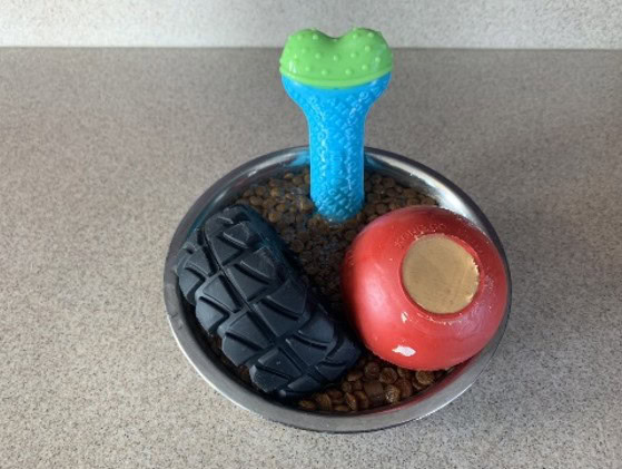 Kongs and toys in a bowl with frozen treats