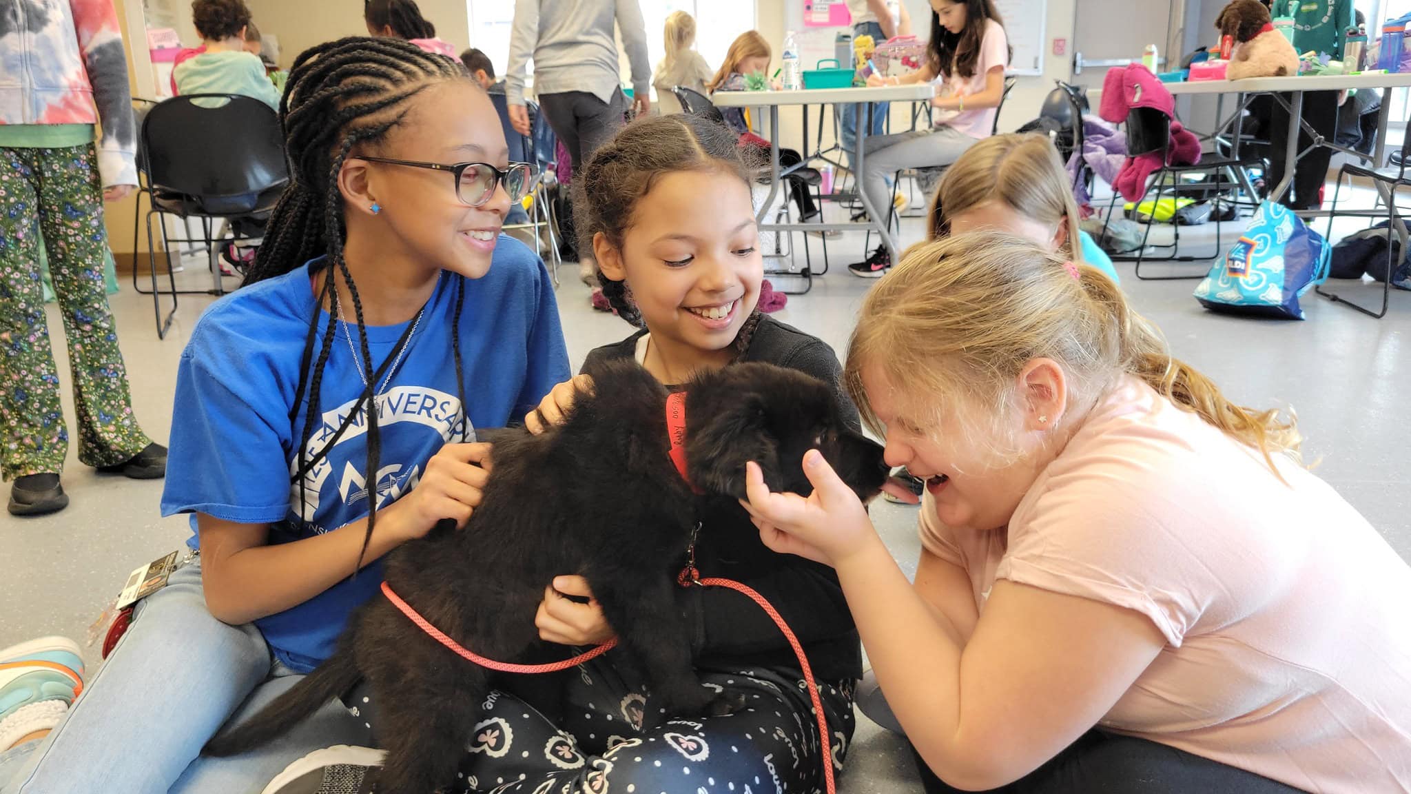 Kids cuddling a puppy