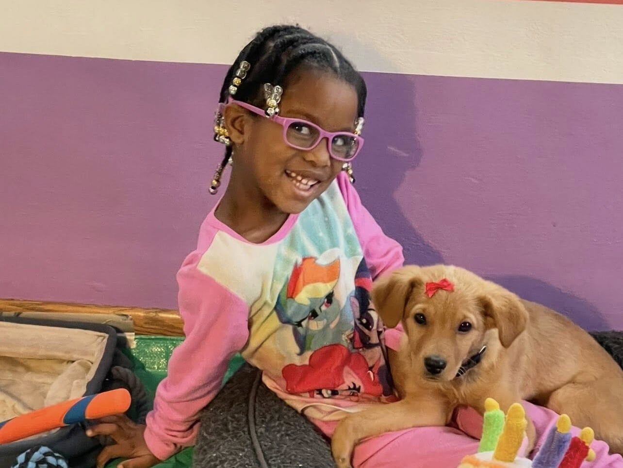 child with puppy on lap